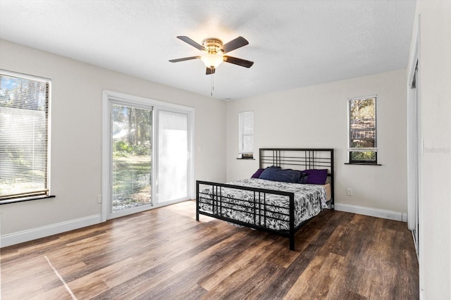 bedroom featuring multiple windows and wood finished floors