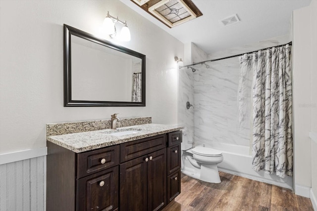 full bathroom featuring visible vents, shower / bathtub combination with curtain, toilet, vanity, and wood finished floors