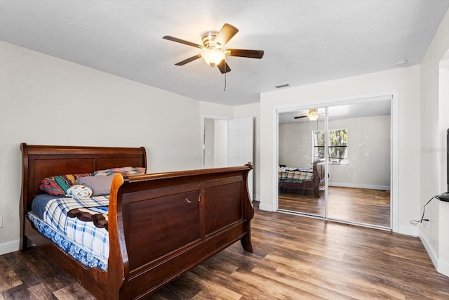 bedroom featuring visible vents, ceiling fan, baseboards, and wood finished floors