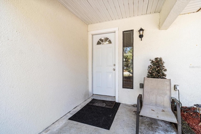 property entrance with stucco siding