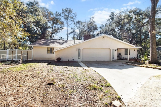 single story home with a chimney, stucco siding, concrete driveway, fence, and a garage