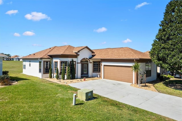 ranch-style house featuring a garage, stucco siding, driveway, and a front yard