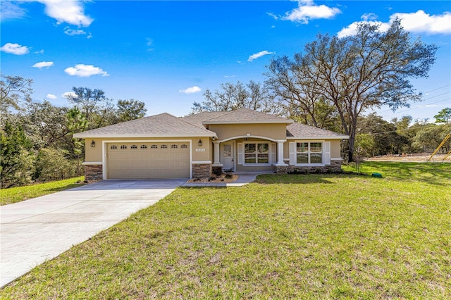 single story home with a garage, driveway, a front yard, and stucco siding