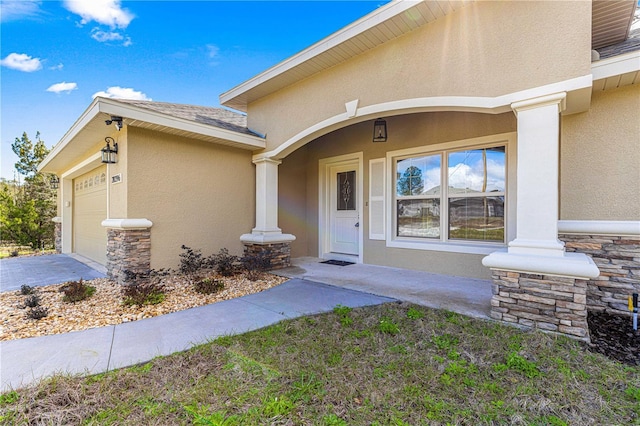 property entrance featuring roof with shingles, stucco siding, a garage, stone siding, and driveway