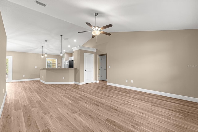 unfurnished living room featuring lofted ceiling, a ceiling fan, visible vents, baseboards, and light wood finished floors