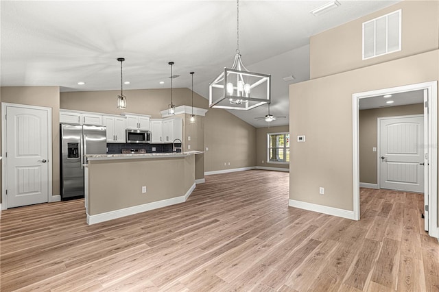 kitchen featuring visible vents, white cabinets, decorative light fixtures, stainless steel appliances, and light countertops