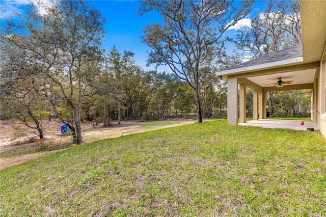 view of yard with a patio area and ceiling fan