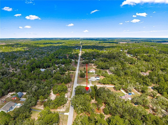 bird's eye view featuring a wooded view