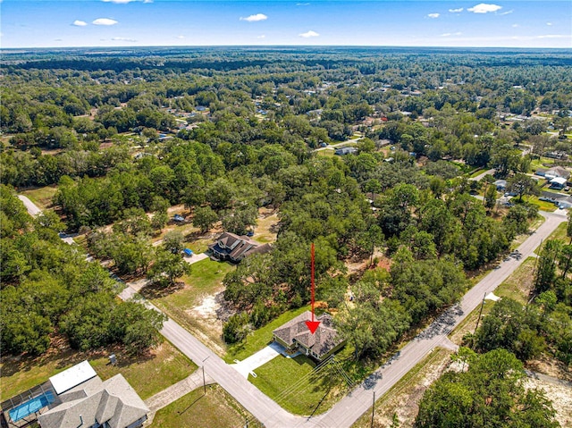 drone / aerial view featuring a view of trees