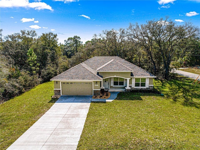 view of front facade with roof with shingles, concrete driveway, a front yard, a garage, and stone siding