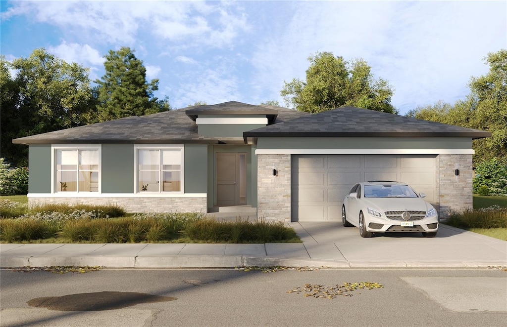 view of front of house featuring driveway, an attached garage, and stucco siding