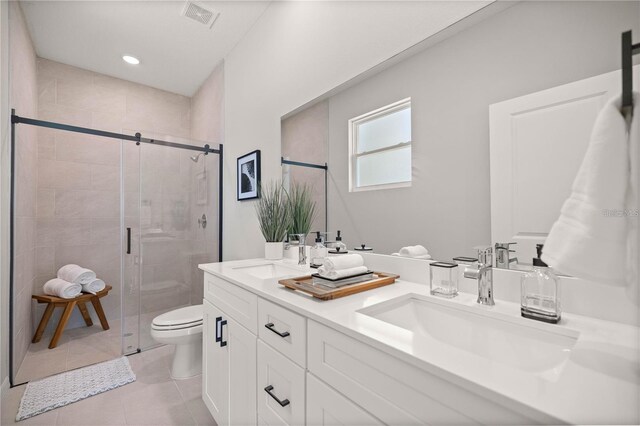 9987 SW 39th Ter, Ocala, FL 34476 - bathroom featuring double vanity, a stall shower, tile patterned flooring, and recessed lighting