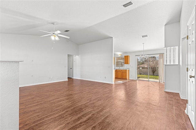 unfurnished living room featuring a textured ceiling, wood finished floors, visible vents, and a ceiling fan