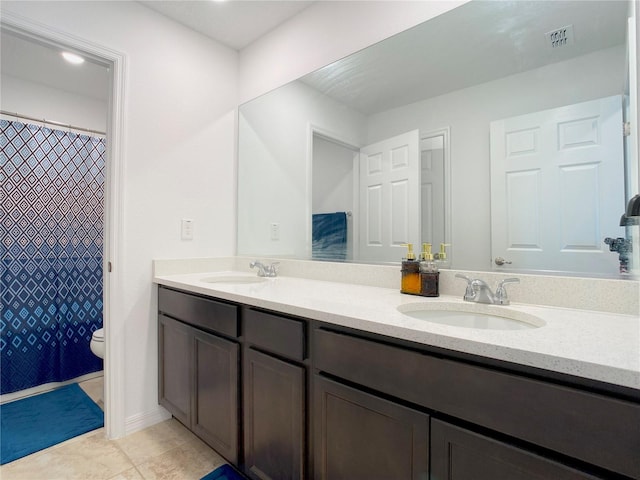 full bath with double vanity, visible vents, toilet, and a sink