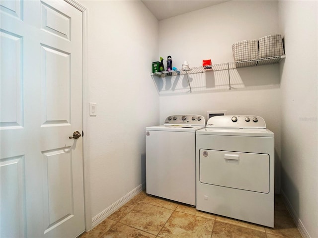 washroom with washer and dryer, laundry area, and baseboards