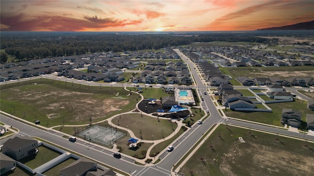 aerial view at dusk featuring a residential view