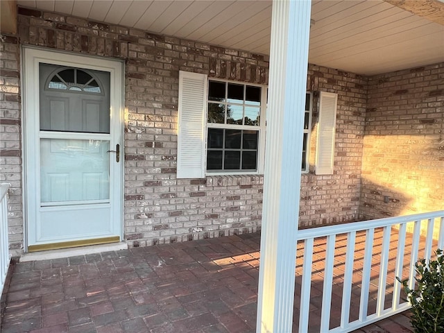 property entrance featuring brick siding