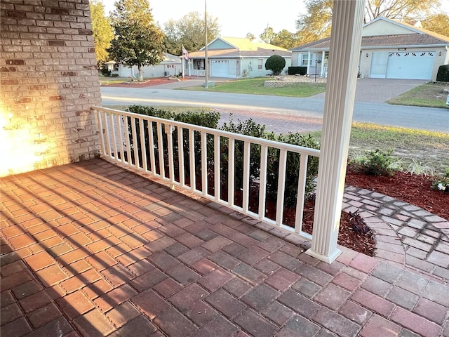 wooden terrace with a residential view and covered porch