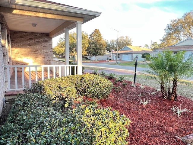 view of yard featuring covered porch