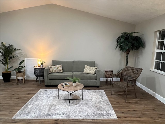 living area with lofted ceiling, dark wood-style flooring, and baseboards