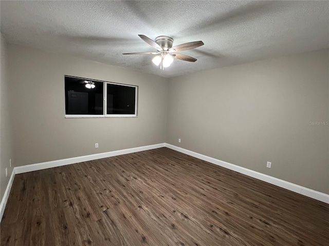 unfurnished room featuring a textured ceiling, baseboards, dark wood finished floors, and a ceiling fan