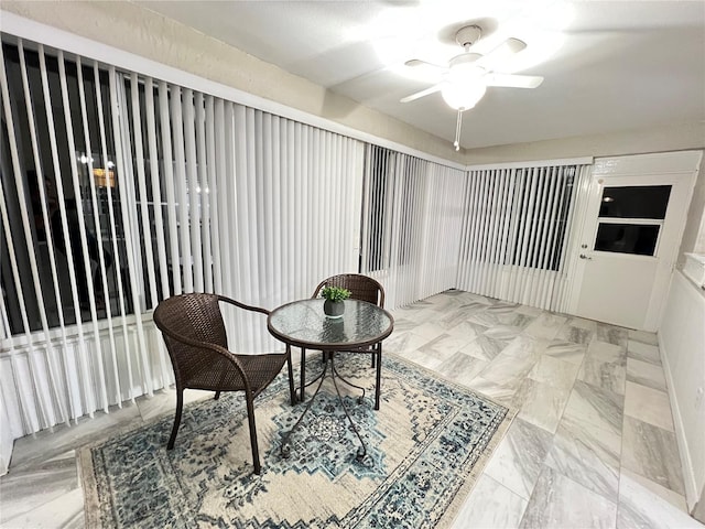 sunroom / solarium featuring ceiling fan