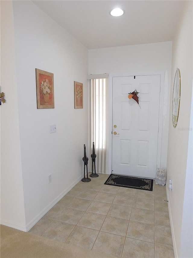 foyer with baseboards and light tile patterned flooring