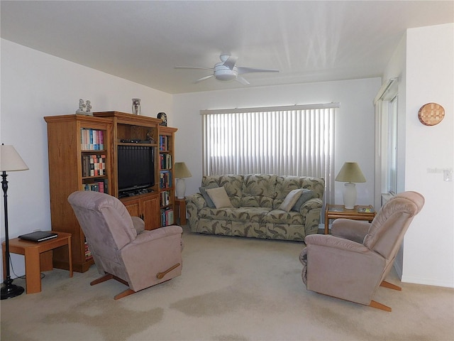 living room featuring a ceiling fan and light colored carpet