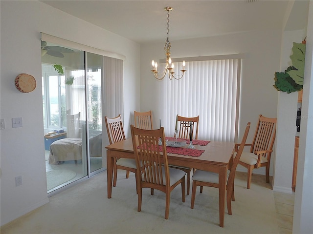 dining area with an inviting chandelier