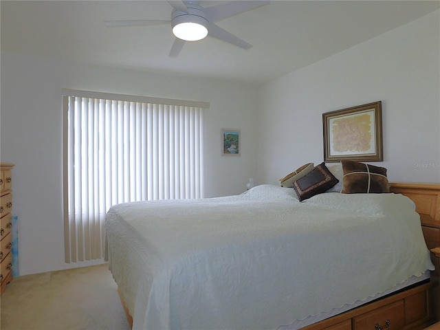 bedroom featuring light carpet and a ceiling fan