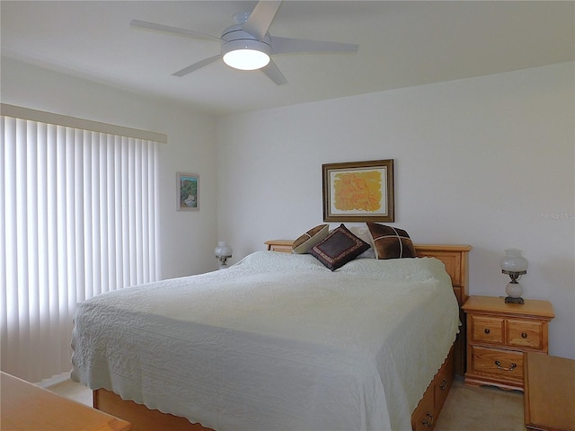 bedroom featuring light carpet and ceiling fan