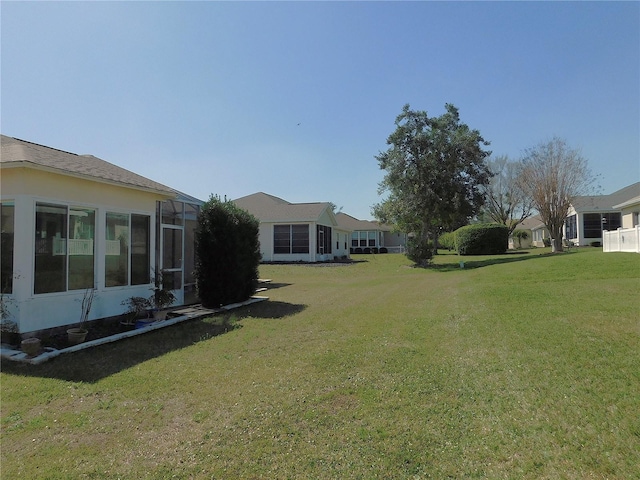 view of yard featuring glass enclosure