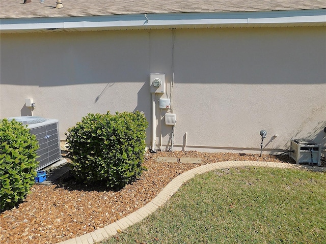 exterior space featuring cooling unit and roof with shingles