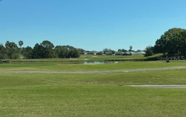 surrounding community featuring a water view and a yard