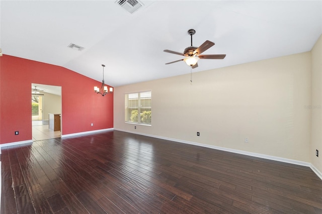 empty room with lofted ceiling, ceiling fan with notable chandelier, wood finished floors, and visible vents