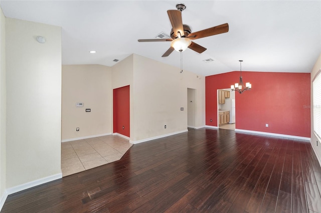 unfurnished room featuring visible vents, vaulted ceiling, and wood finished floors