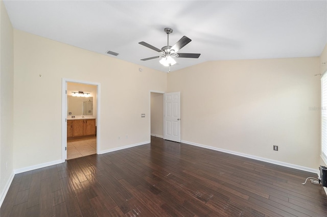 spare room featuring lofted ceiling, wood-type flooring, visible vents, ceiling fan, and baseboards