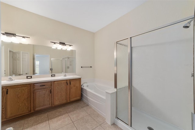 full bath featuring double vanity, a sink, a shower stall, tile patterned flooring, and a bath