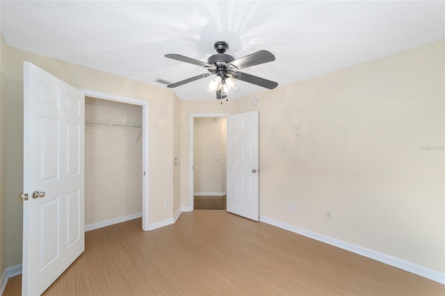 unfurnished bedroom with a closet, baseboards, ceiling fan, and light wood finished floors