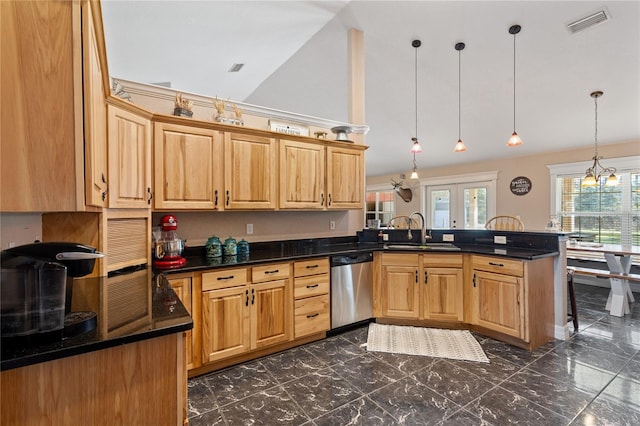 kitchen featuring dark countertops, decorative light fixtures, a peninsula, stainless steel dishwasher, and a sink