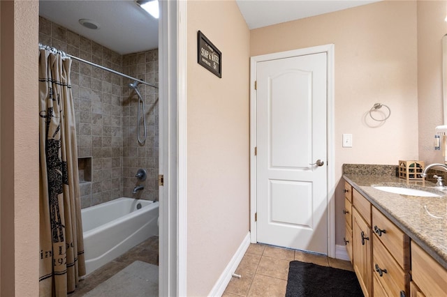 bathroom featuring shower / tub combo, tile patterned flooring, baseboards, and vanity