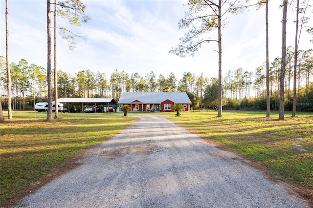 view of front facade with a carport, driveway, and a front lawn