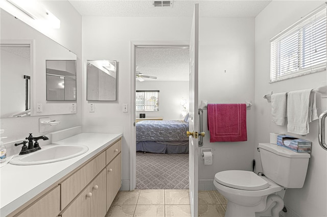 ensuite bathroom with visible vents, toilet, ensuite bath, tile patterned floors, and a textured ceiling