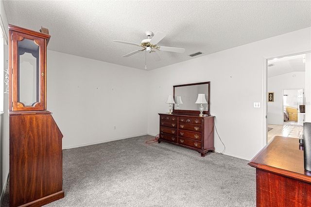 carpeted bedroom featuring a ceiling fan, visible vents, and a textured ceiling