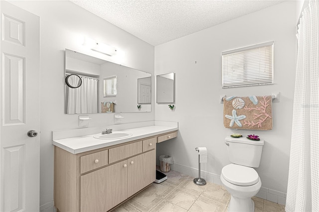 bathroom with baseboards, a textured ceiling, toilet, and vanity