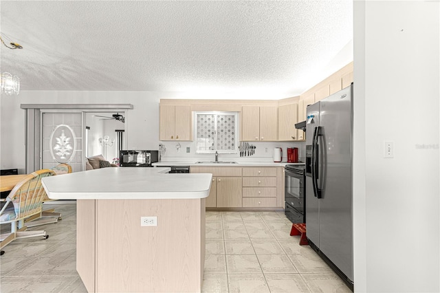 kitchen featuring light countertops, a textured ceiling, black appliances, light brown cabinets, and a sink