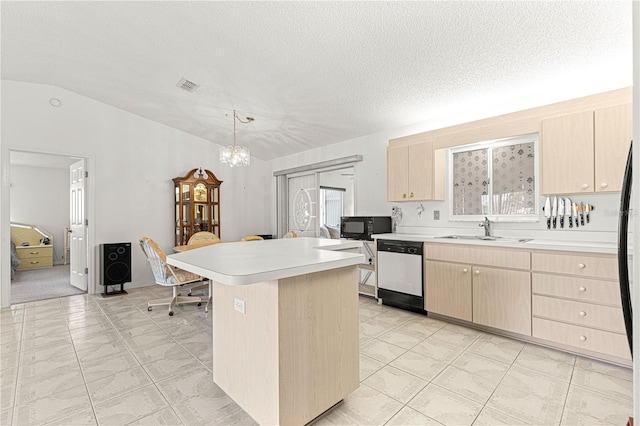 kitchen with light brown cabinetry, vaulted ceiling, a sink, black microwave, and dishwashing machine