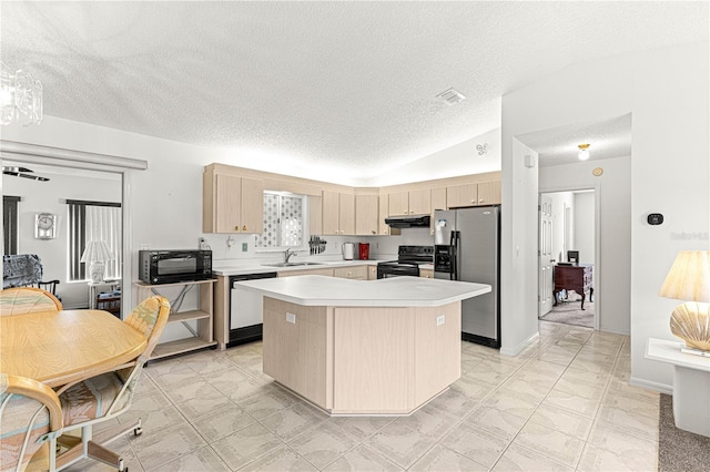 kitchen with under cabinet range hood, light countertops, black appliances, light brown cabinets, and a sink