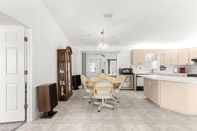 dining space featuring a textured ceiling, a chandelier, and visible vents