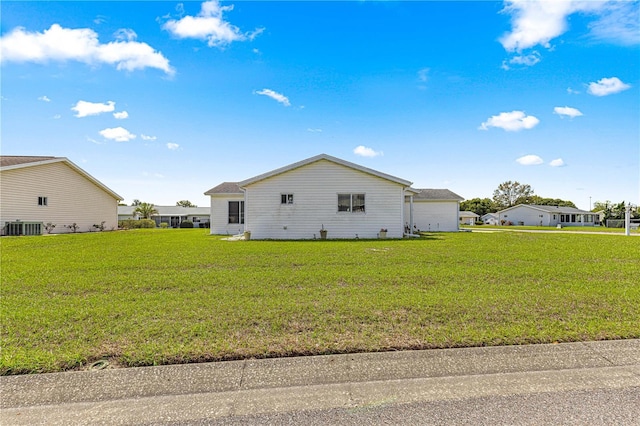 view of property exterior featuring a yard and central air condition unit